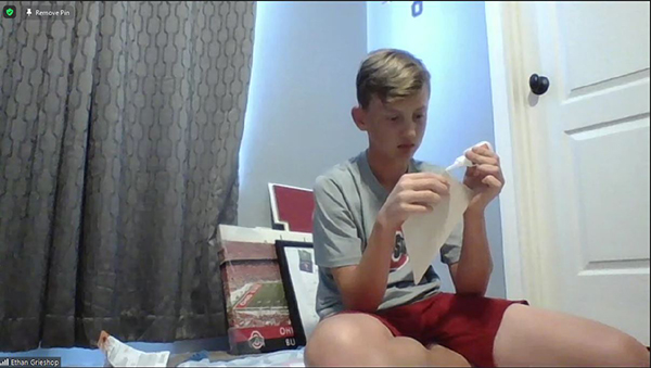 An aerospace GAMES camper flies a simulation plane.