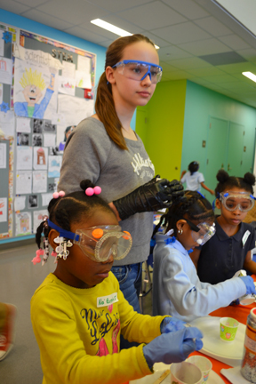 Next Gen middle school student supervises BTW kindergarteners during hands-on project making superballs.