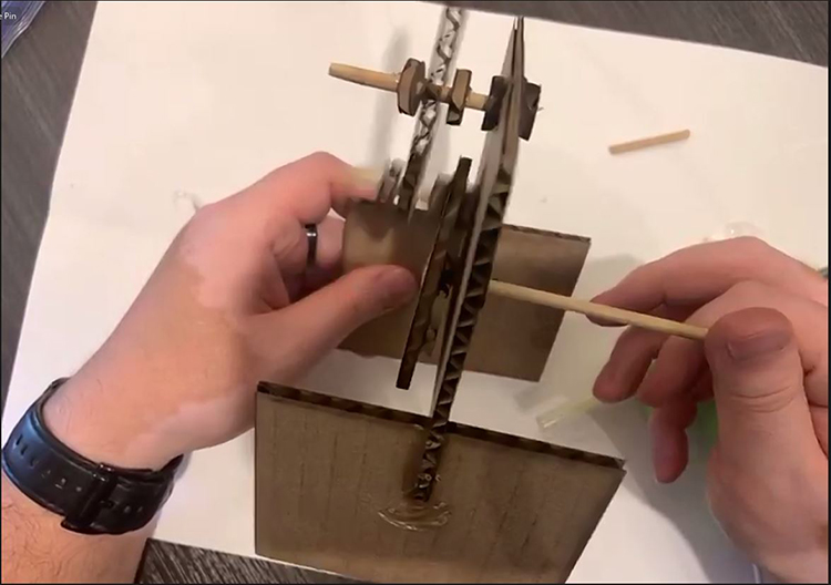 Jesus Zavala demonstrates how to construct one of the mechatronics projects during a Zoom session.